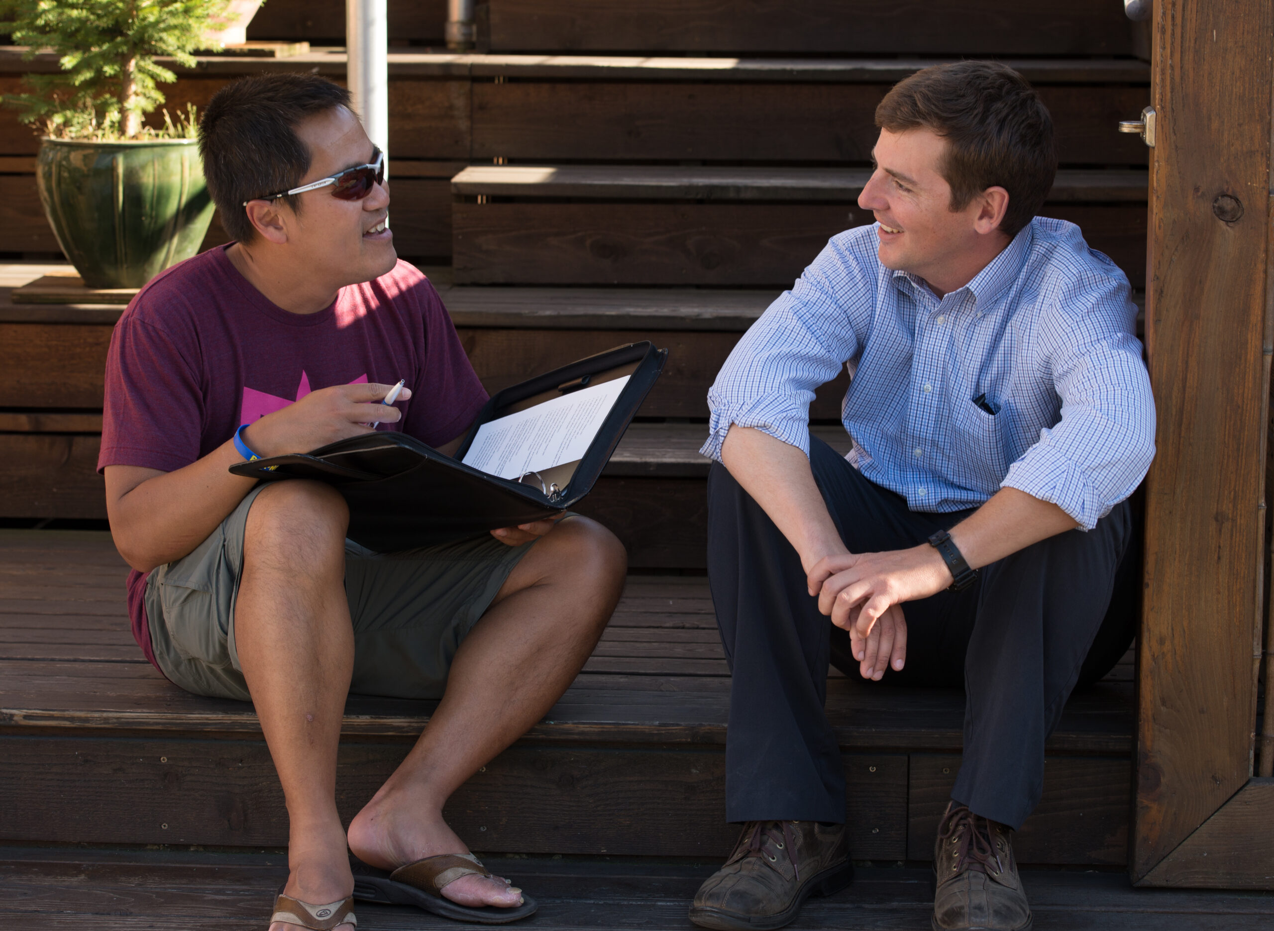 Two people sitting on a step having a lively conversation